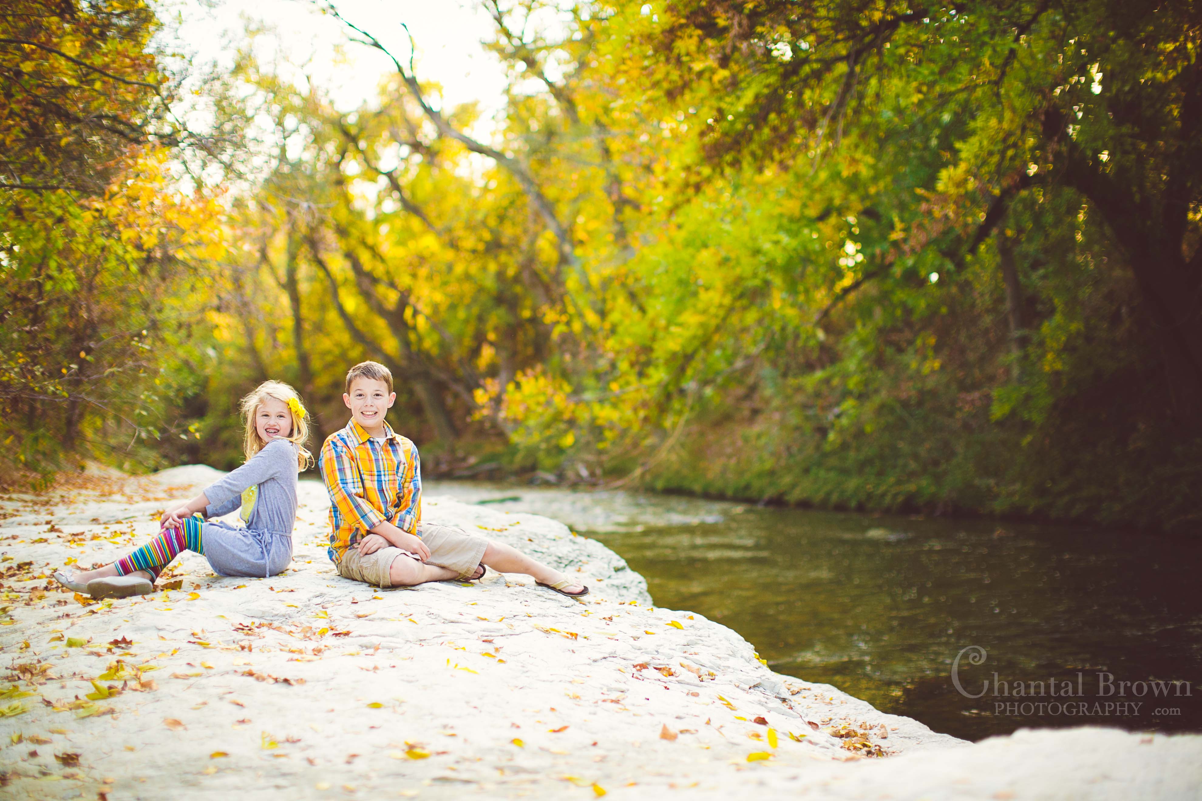 Richardson-Breckinridge-Park-12 Children portrait photography at Breckinridge Park in Richardson Texas setting on white rocks in creek area near water and lovely gorgeous yellow brown autumn fall leave colors